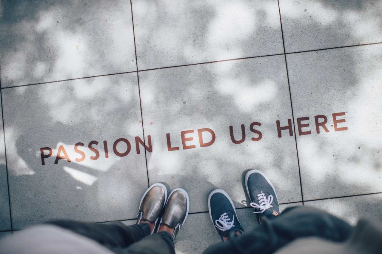 Mission Image: Two people’s feet standing in front of the words “passion led us here”