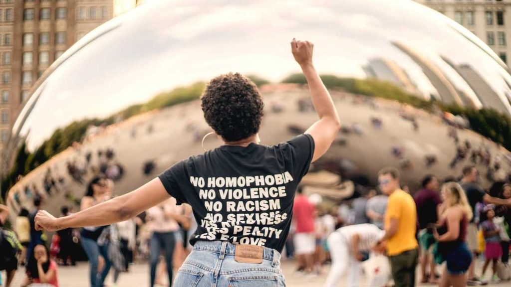 Values image: person of color with their back towards camera wearing a black t-shirt