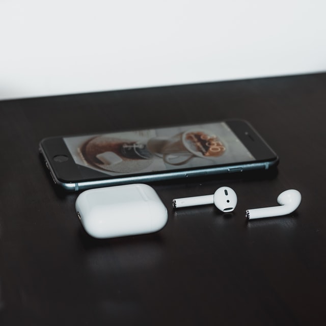 Iphone and airpods on a table