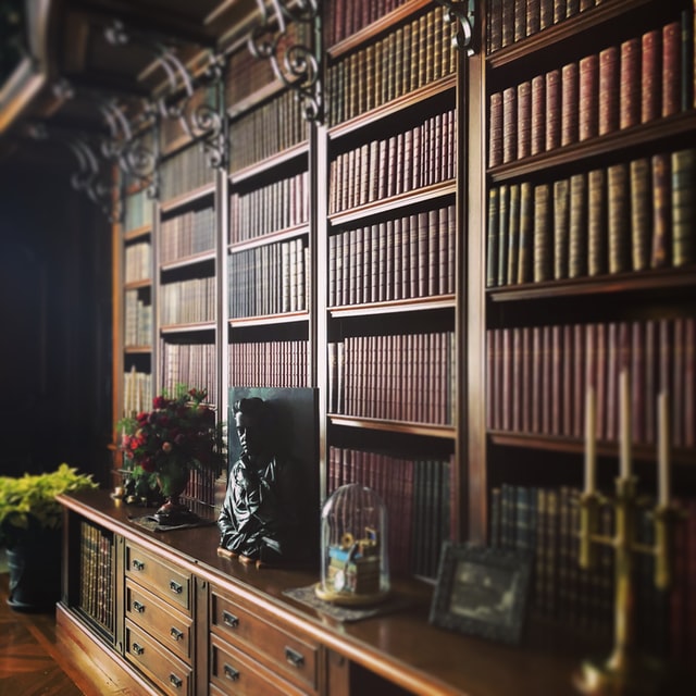 Large wooden bookshelf with books and knickknacks on it